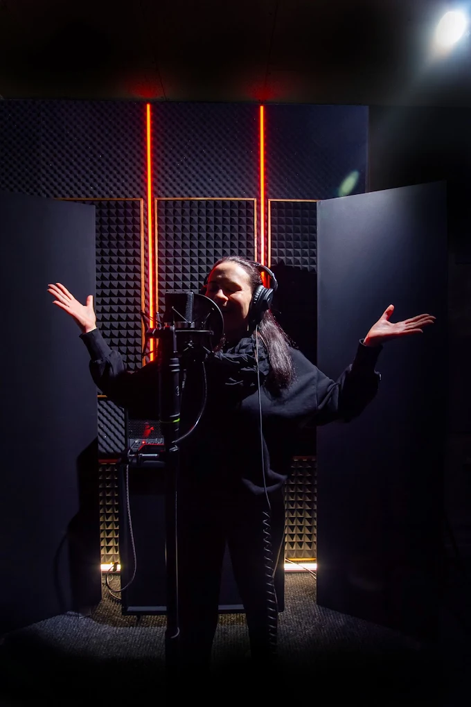 Singer tracking vocals under red light